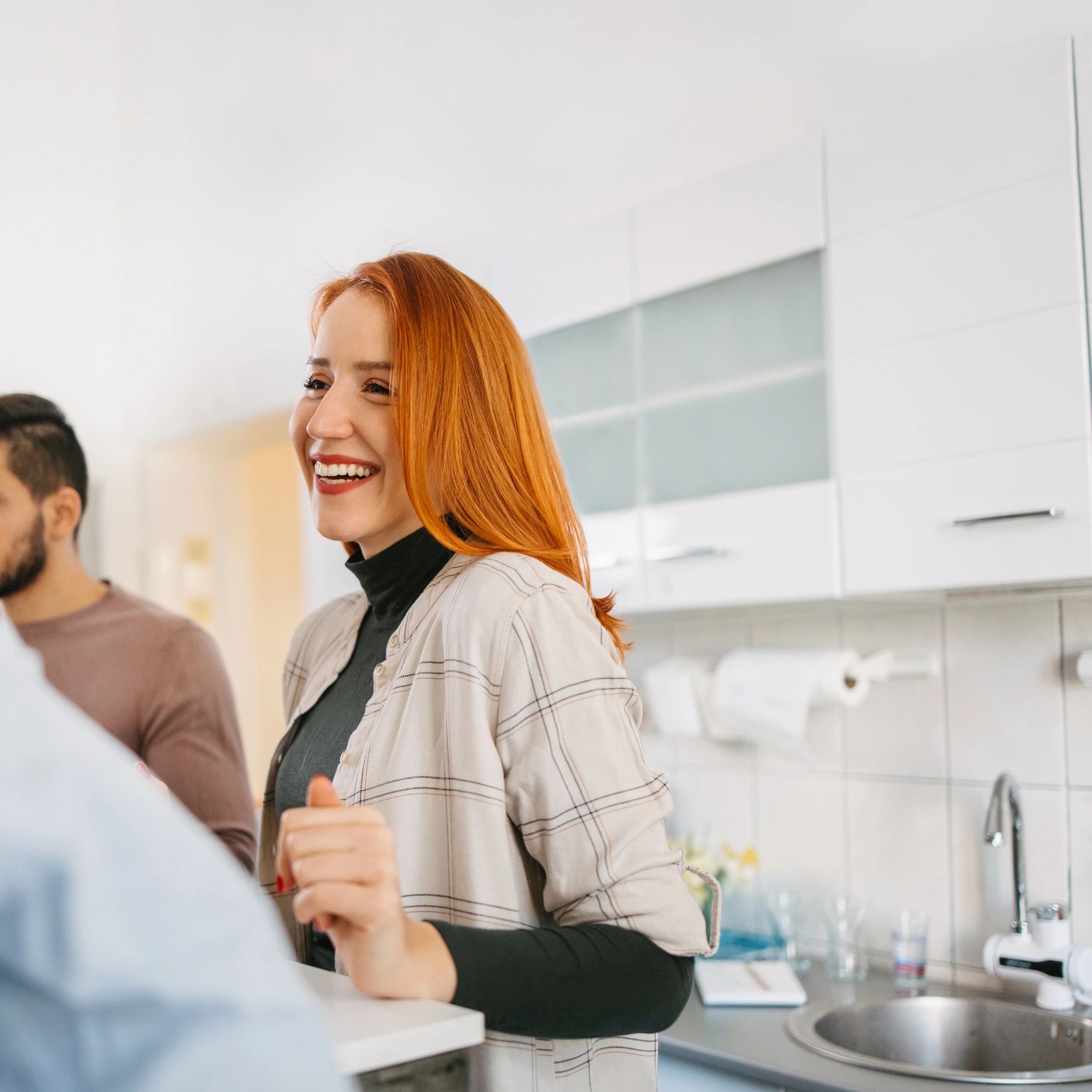 Smiling homeowner in kitchen after cabinetry project